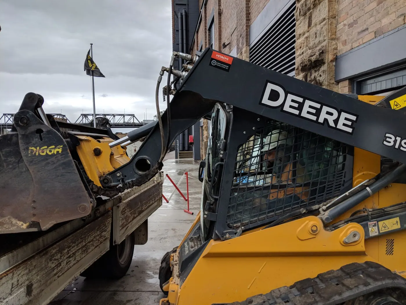 Posi-track loading a truck on a Sydney site